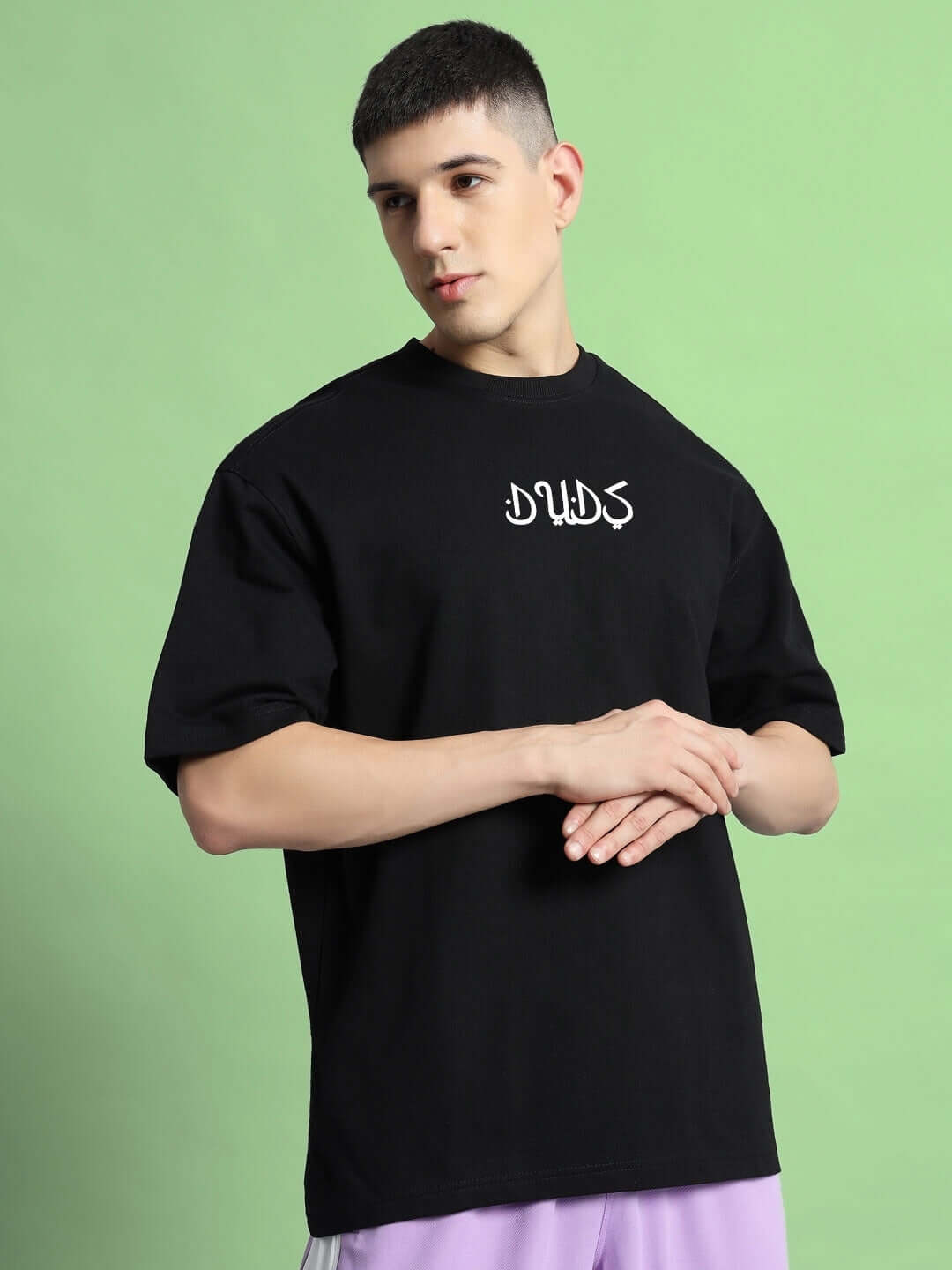 Model wearing DIMENSION over-sized black t-shirt, made from premium heavy gauge fabric, featuring a stylish design.