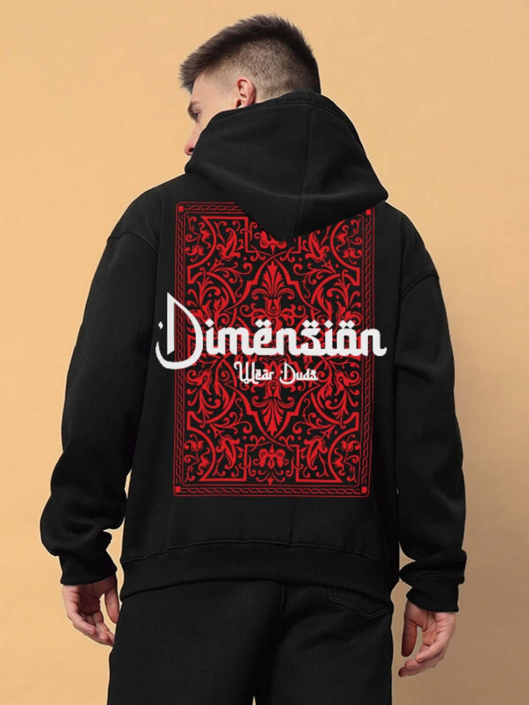 Black Dimension cotton fleece hoodie with red ornate back design, worn by a model. Perfect for casual wear.