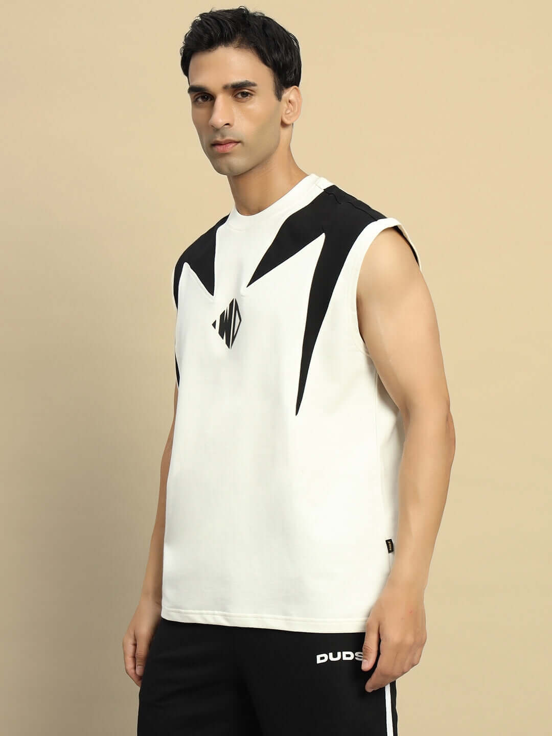 Man wearing DINO THUNDER oversized off-white T-shirt with black geometric design, made of premium cotton and elastane blend.