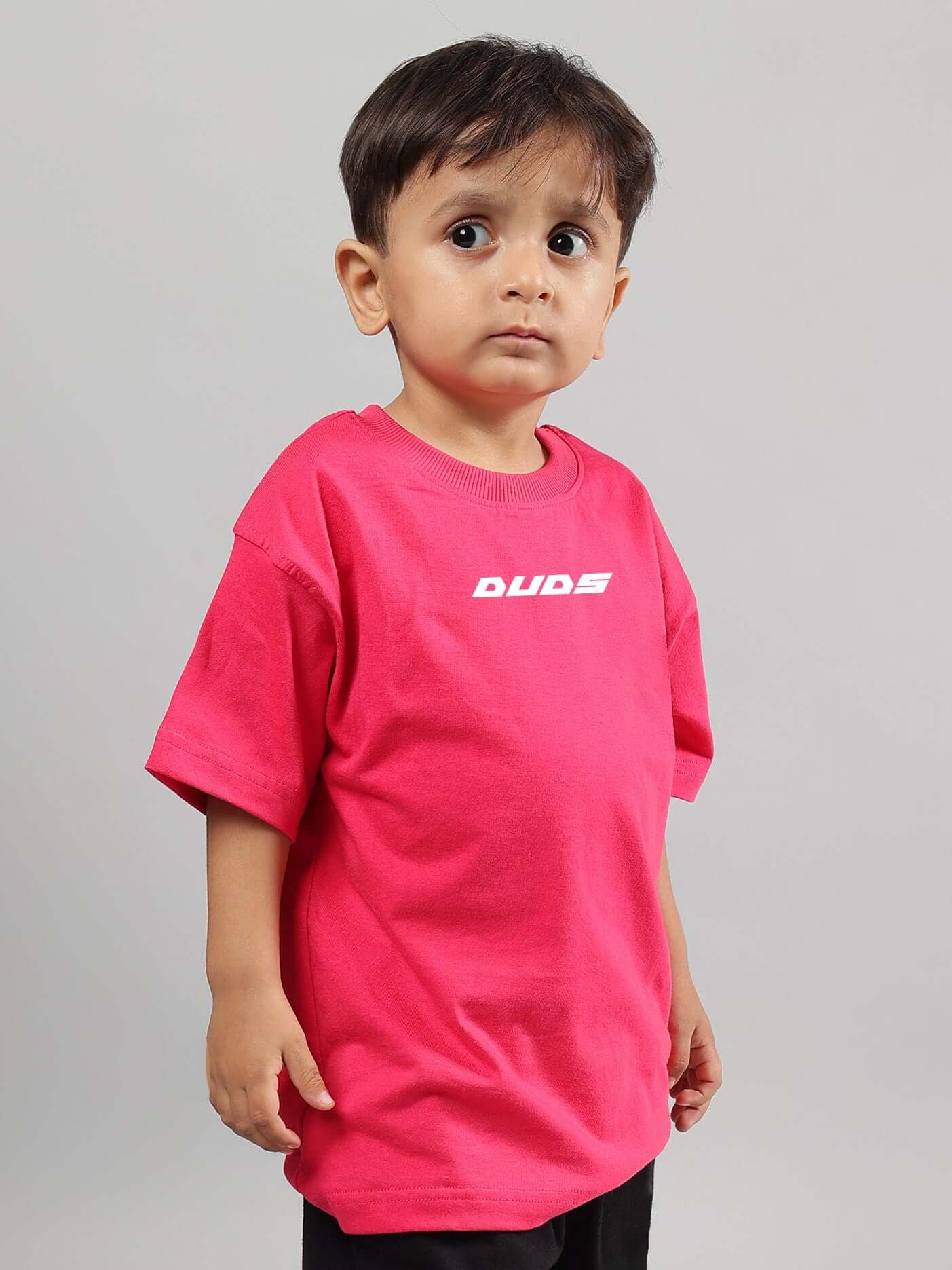Child wearing Disney Lilo oversized pink t-shirt with DUDS logo.