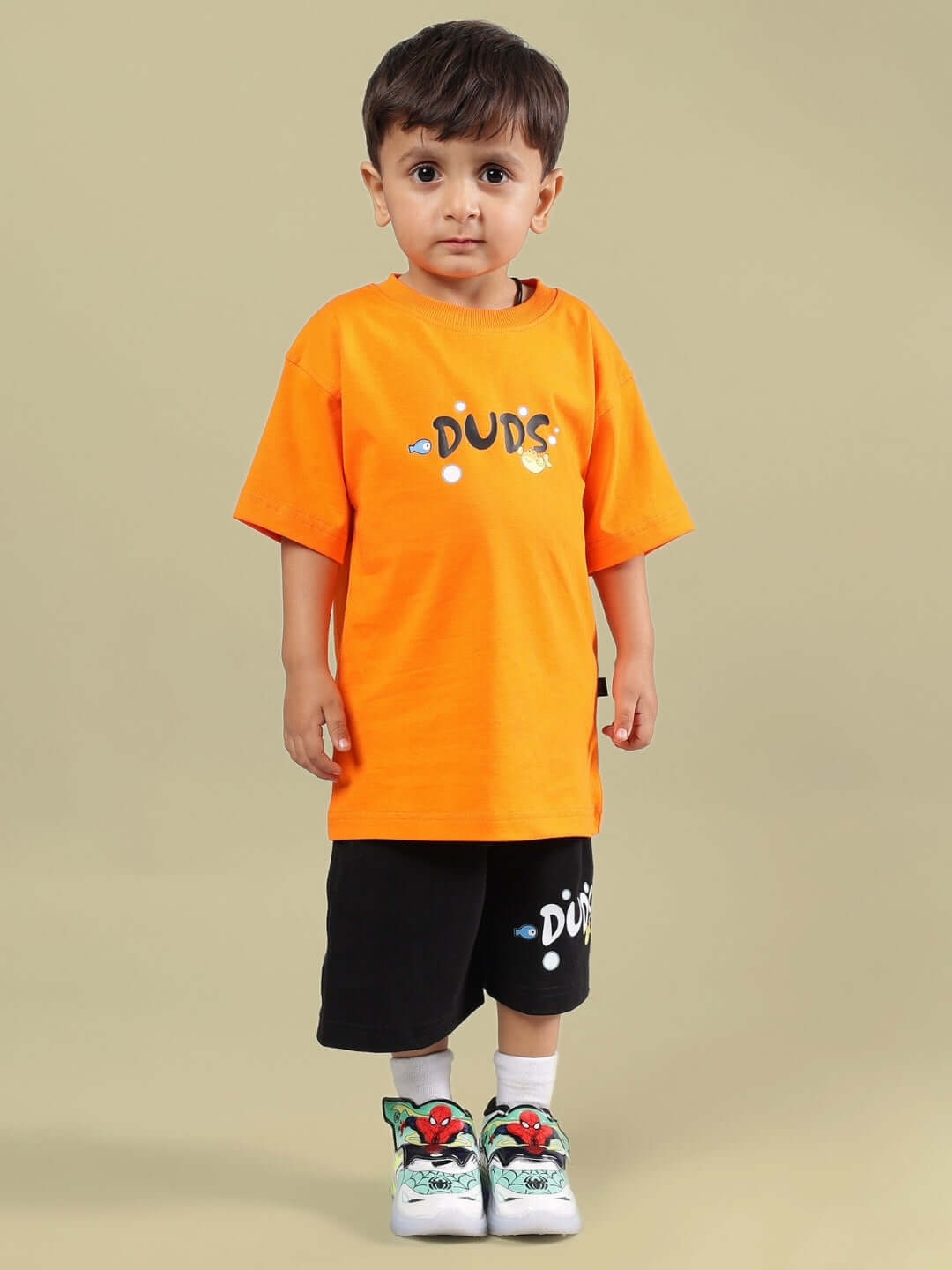 Child wearing DIVING BEAR CO-ORD FOR BOYS & GIRLS ORANGE-BLACK, featuring orange t-shirt and black shorts by DUDS.