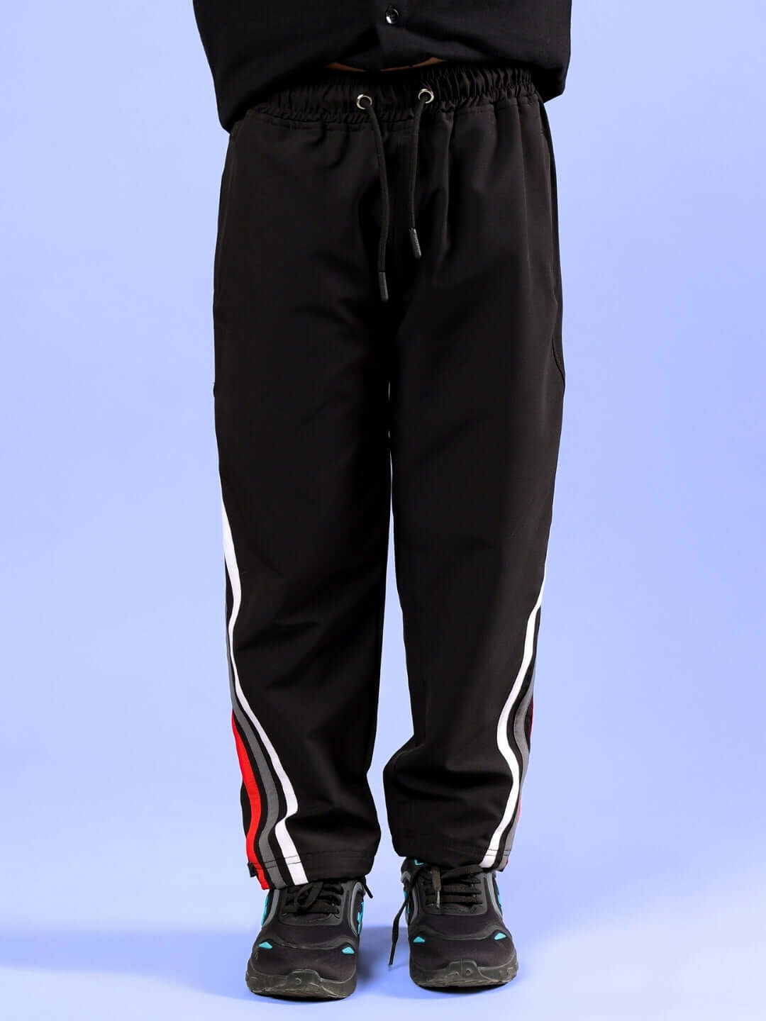 DOBBIN JOGGER FOR BOYS & GIRLS BLACK with stripe detailing, shown on a model, made to order with customization option available.