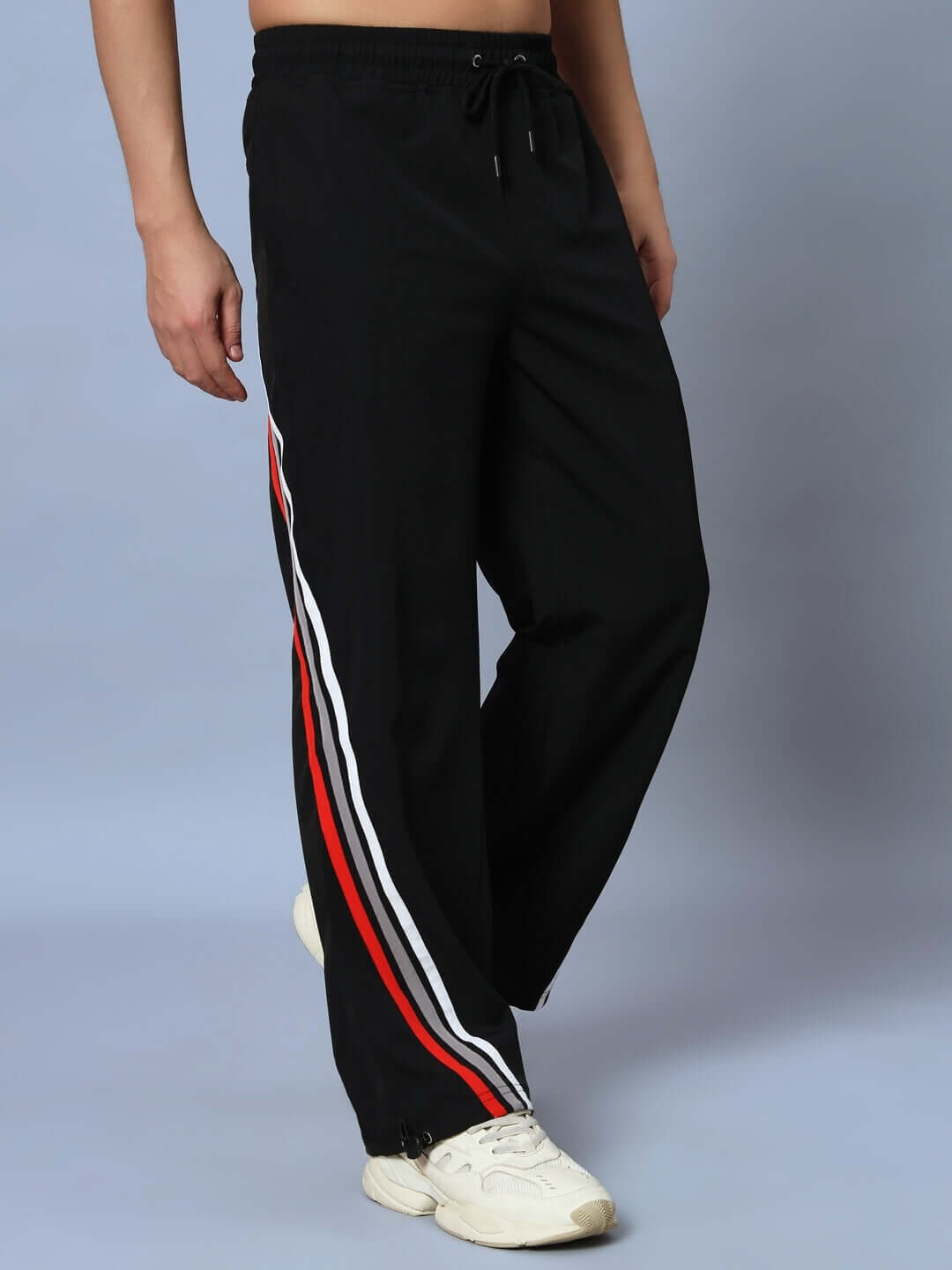 Model wearing Dobbin Relaxed Fit Jogger in black with side stripes.