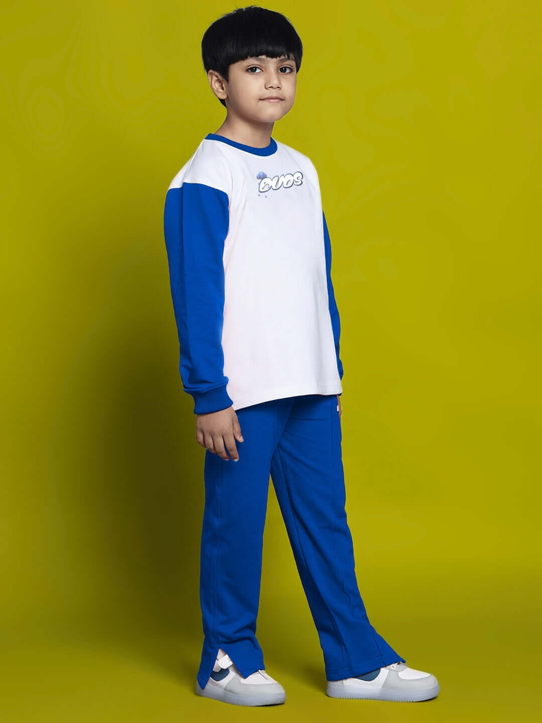 Boy wearing DORAEMON CO-ORD SET FOR BOYS GIRLS WHITE BLUE with t-shirt and matching shorts, featuring playful design for kids.