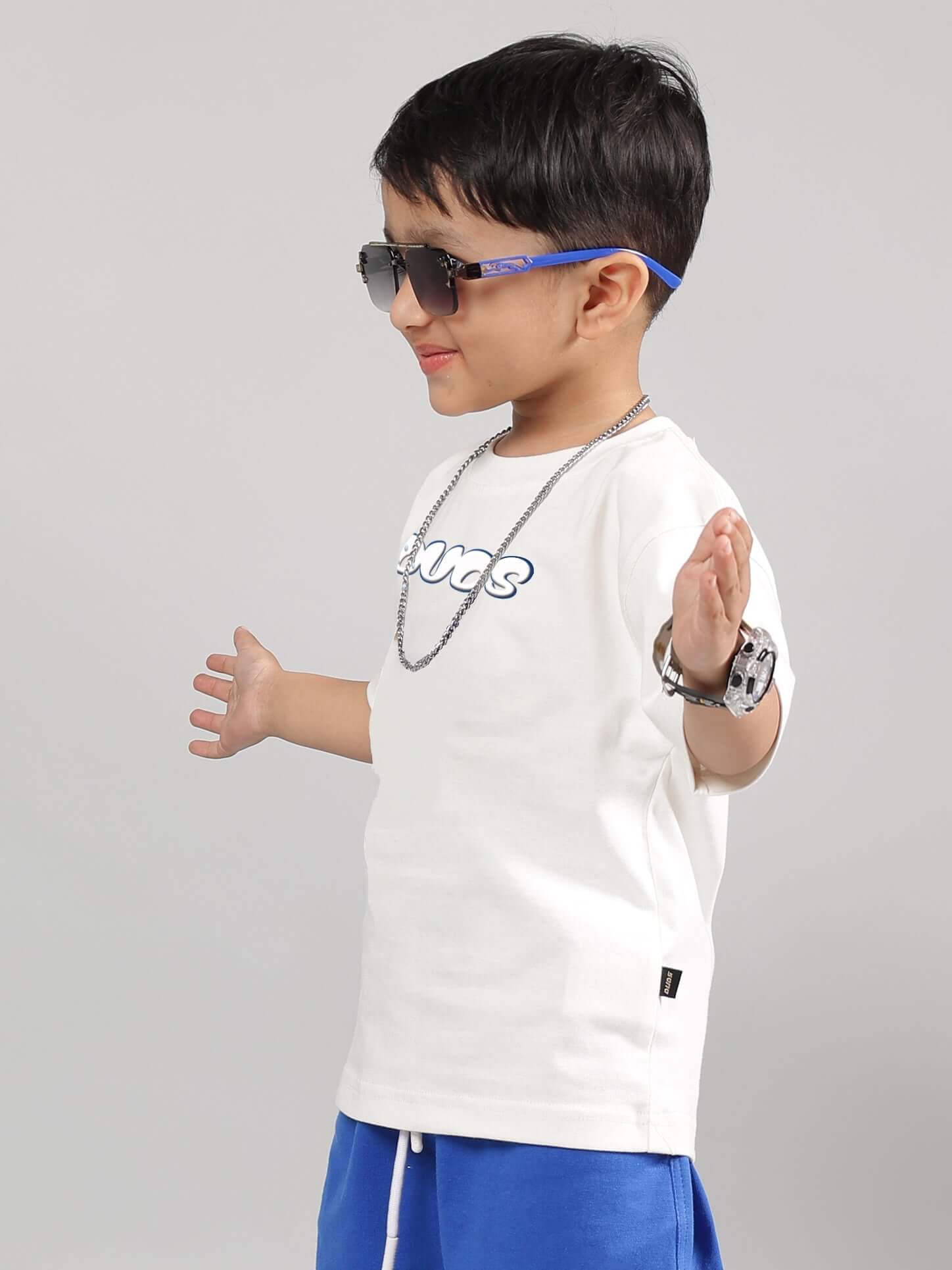 DORAEMON T-SHIRT FOR BOYS GIRLS OFF WHITE modeled by child with sunglasses and blue shorts