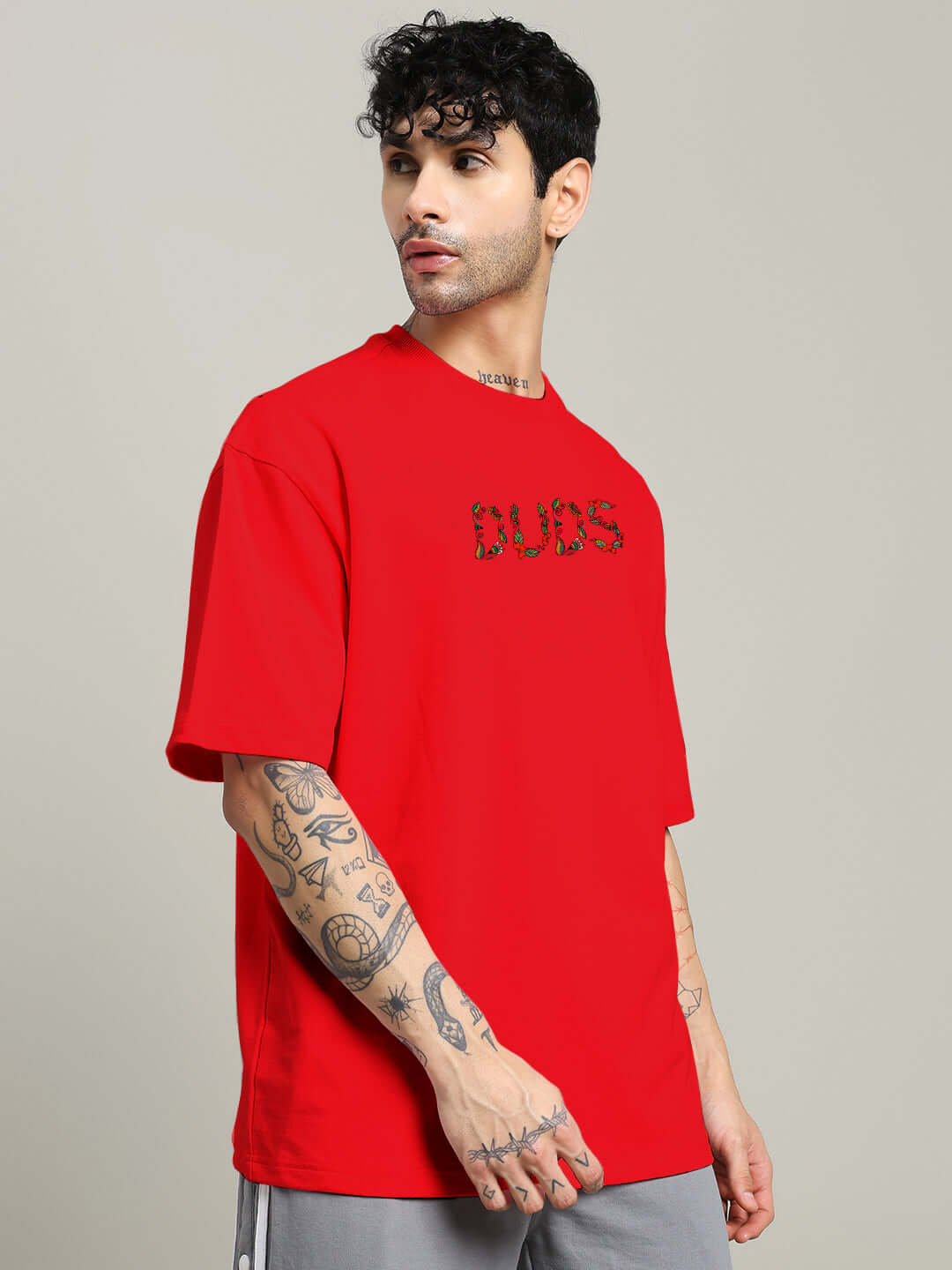 Model wearing a red oversized DRAGONFLY T-shirt made of premium cotton French terry, featuring graphic text, ideal for casual wear.