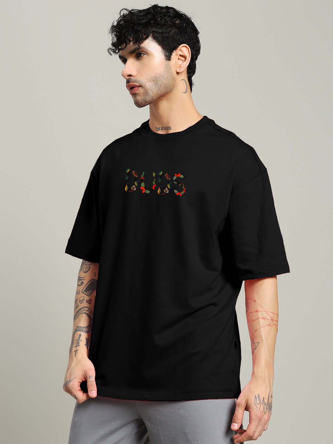 Model wearing Dragonfly Oversized Black T-shirt made of premium cotton fabric by Color By Colours, featuring vibrant graphic details.
