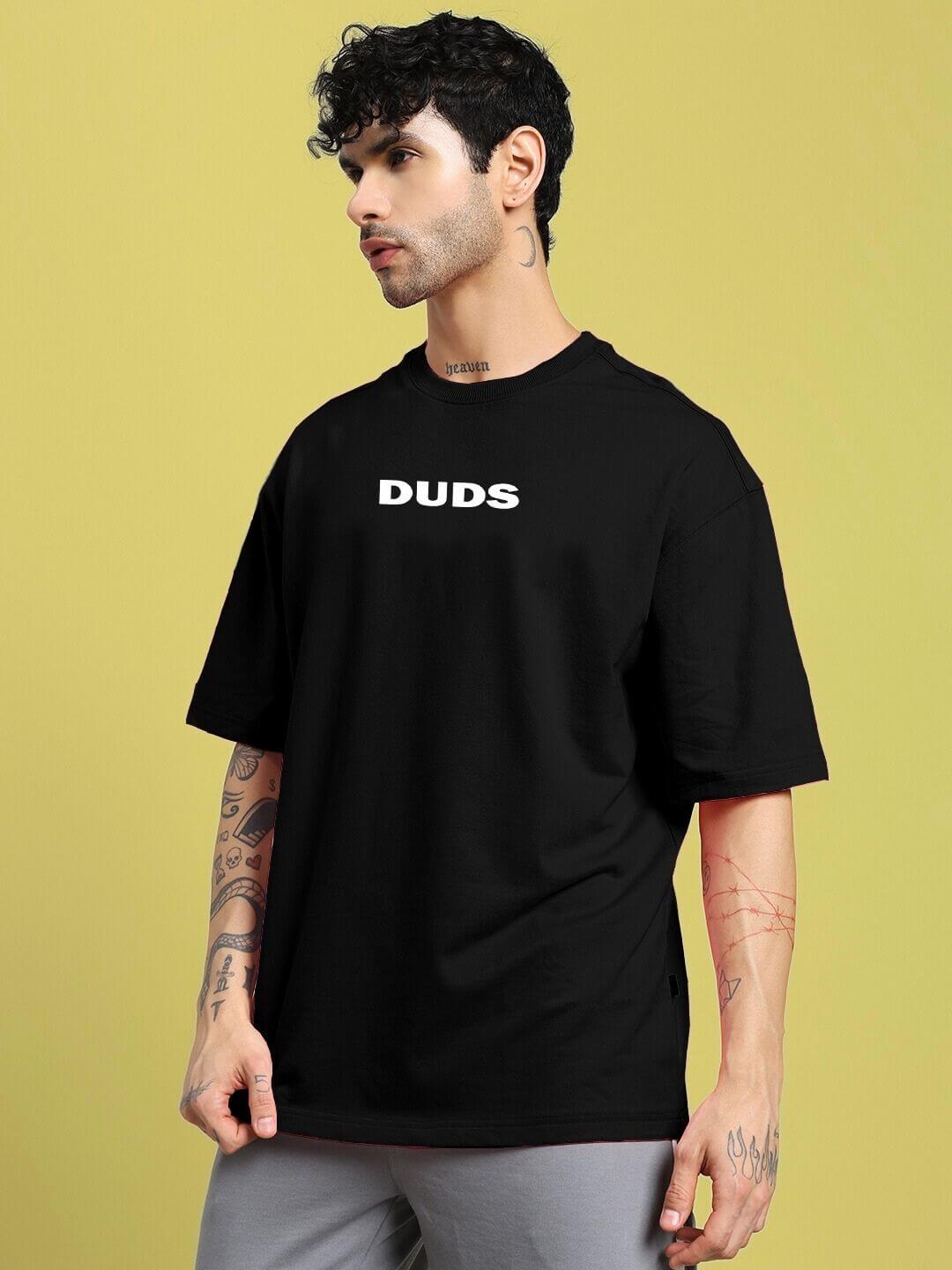 Model wearing DREAMLESS OVER-SIZED T-SHIRT BLACK, showcasing minimalist streetwear style with oversized fit for modern urban fashion.