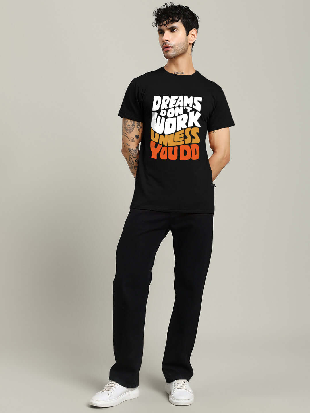 Man wearing DREAMS REGULAR FIT T-SHIRT BLACK with motivational text, casual look