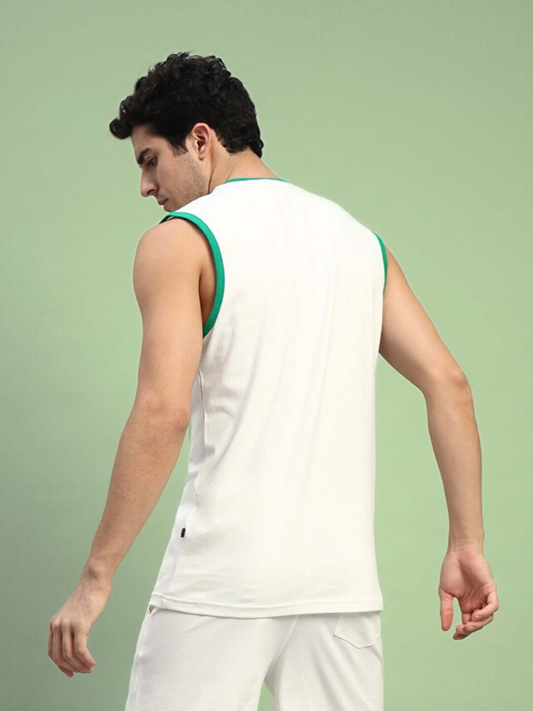 Back view of model wearing DRIBBLE OVER-SIZED T-SHIRT OFF-WHITE showcasing relaxed fit and contemporary style.