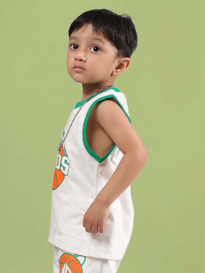 DRIBBLE T-SHIRT FOR BOYS & GIRLS OFF WHITE modeled by young boy against green background