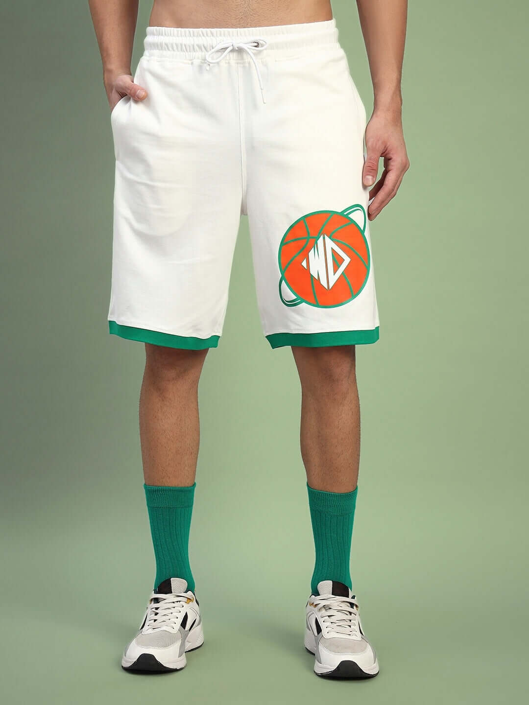 Model wearing DRIBBLE CO-ORD SET SLEEVELESS OFF WHITE with sporty shorts and sneakers, showcasing summer streetwear style.