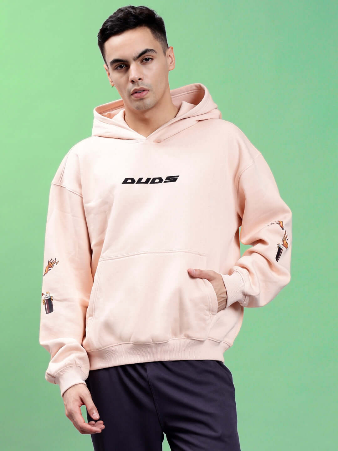 Model wearing DRIP CUPID OVERSIZED HOODIES BEIGE, showcasing streetwear style with a bold graphic design, relaxed fit, and soft beige tone.