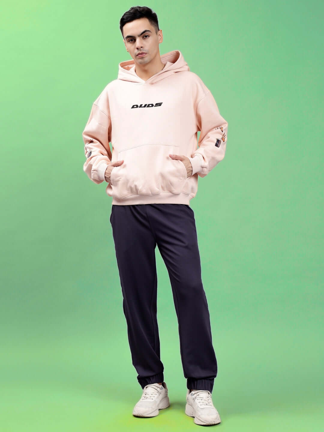 Model wearing DRIP CUPID OVERSIZED HOODIES BEIGE, showcasing relaxed streetwear style with soft beige tone and bold graphic design.