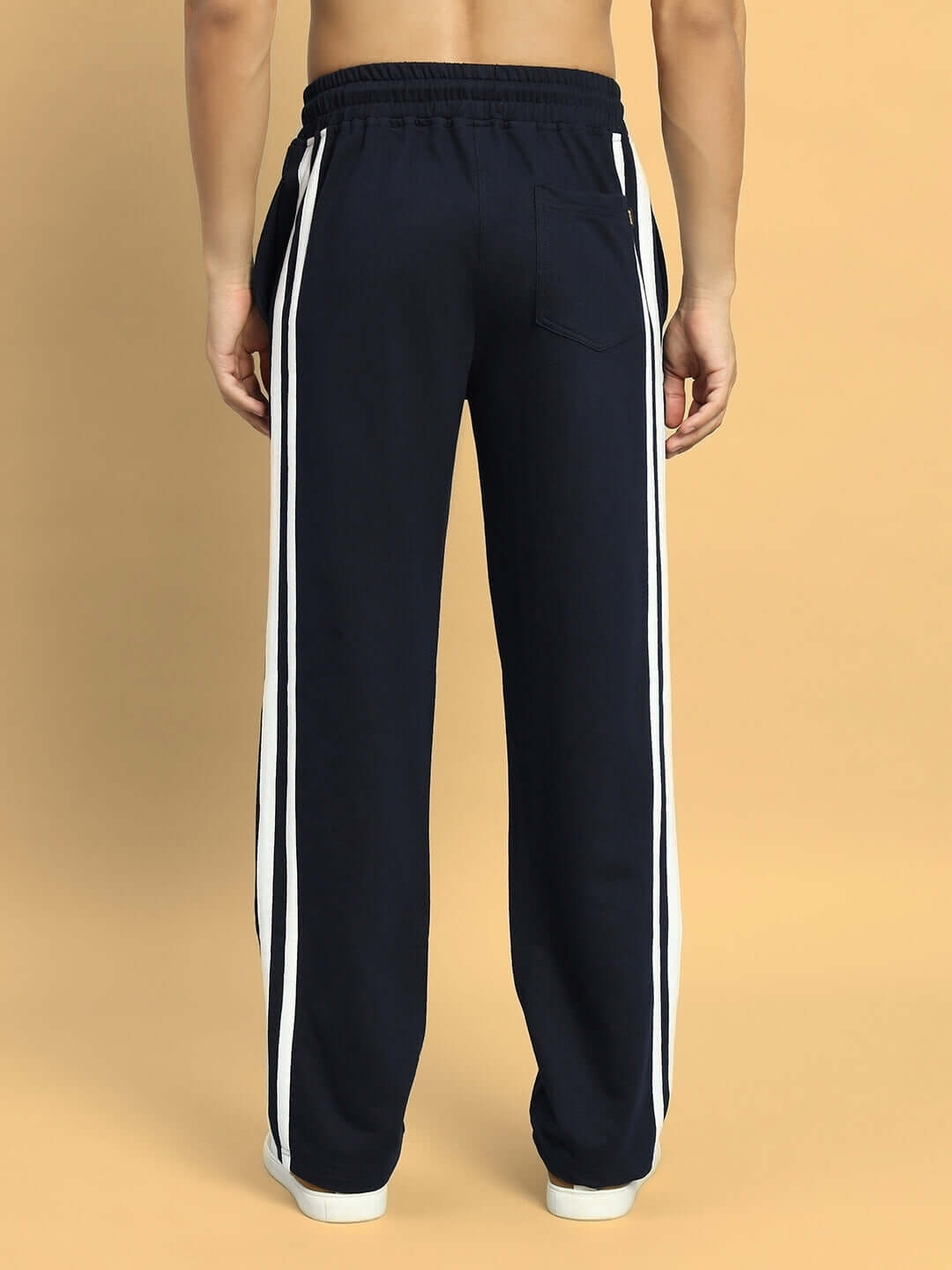 Back view of navy blue DROOP RELAXED JOGGERS with white side stripes, showcasing comfortable fit and stylish design.