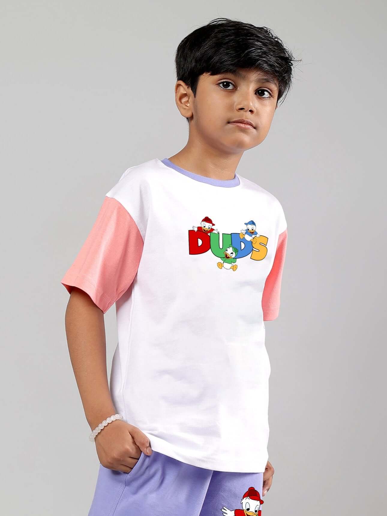 Boy wearing white and pink DUDS branded duck play t-shirt, suitable for both boys and girls.