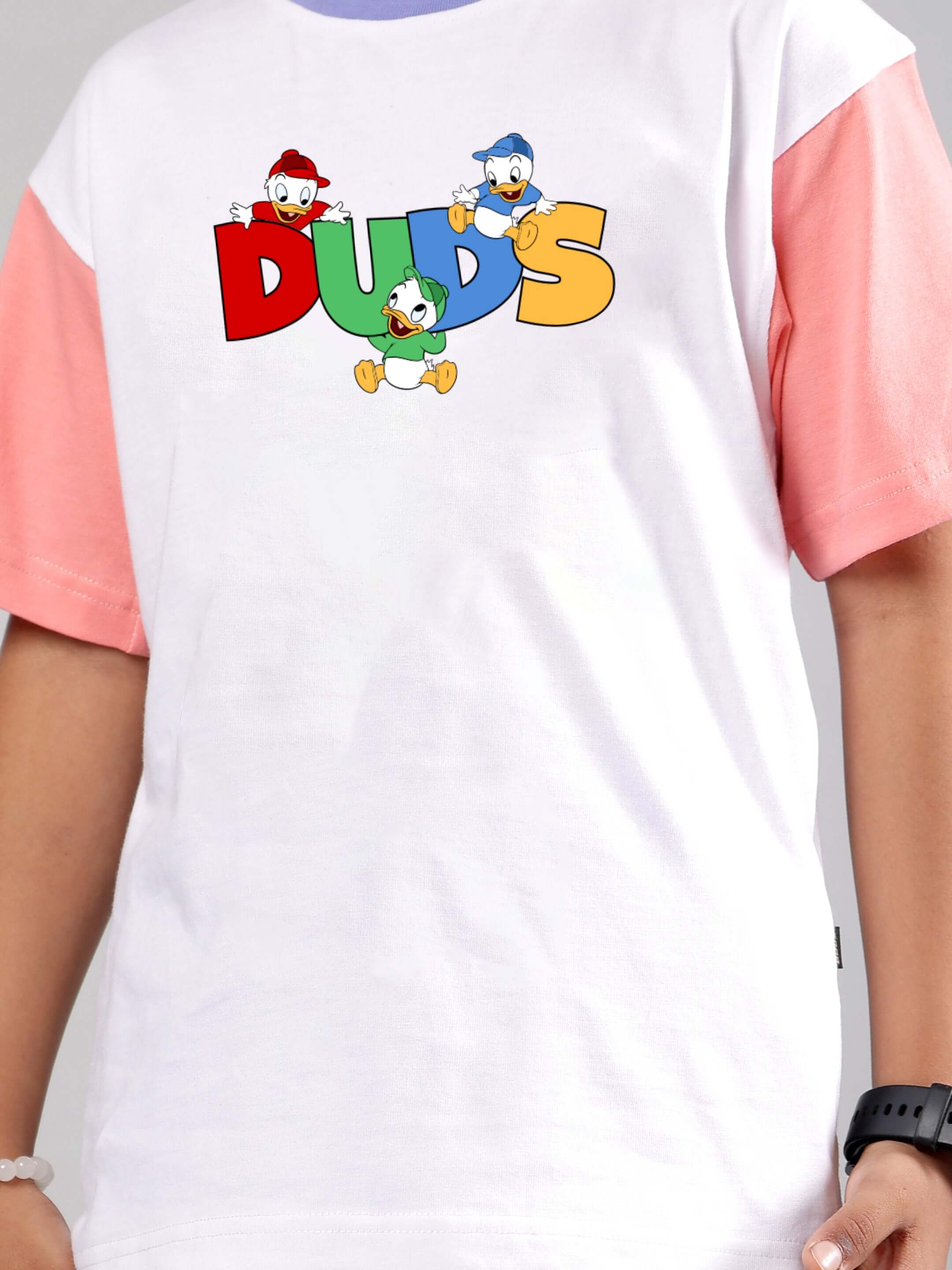 White and pink 'DUCK PLAY' kids t-shirt with colorful duck design, high-quality tailoring by DUDS, customizable fit option available.