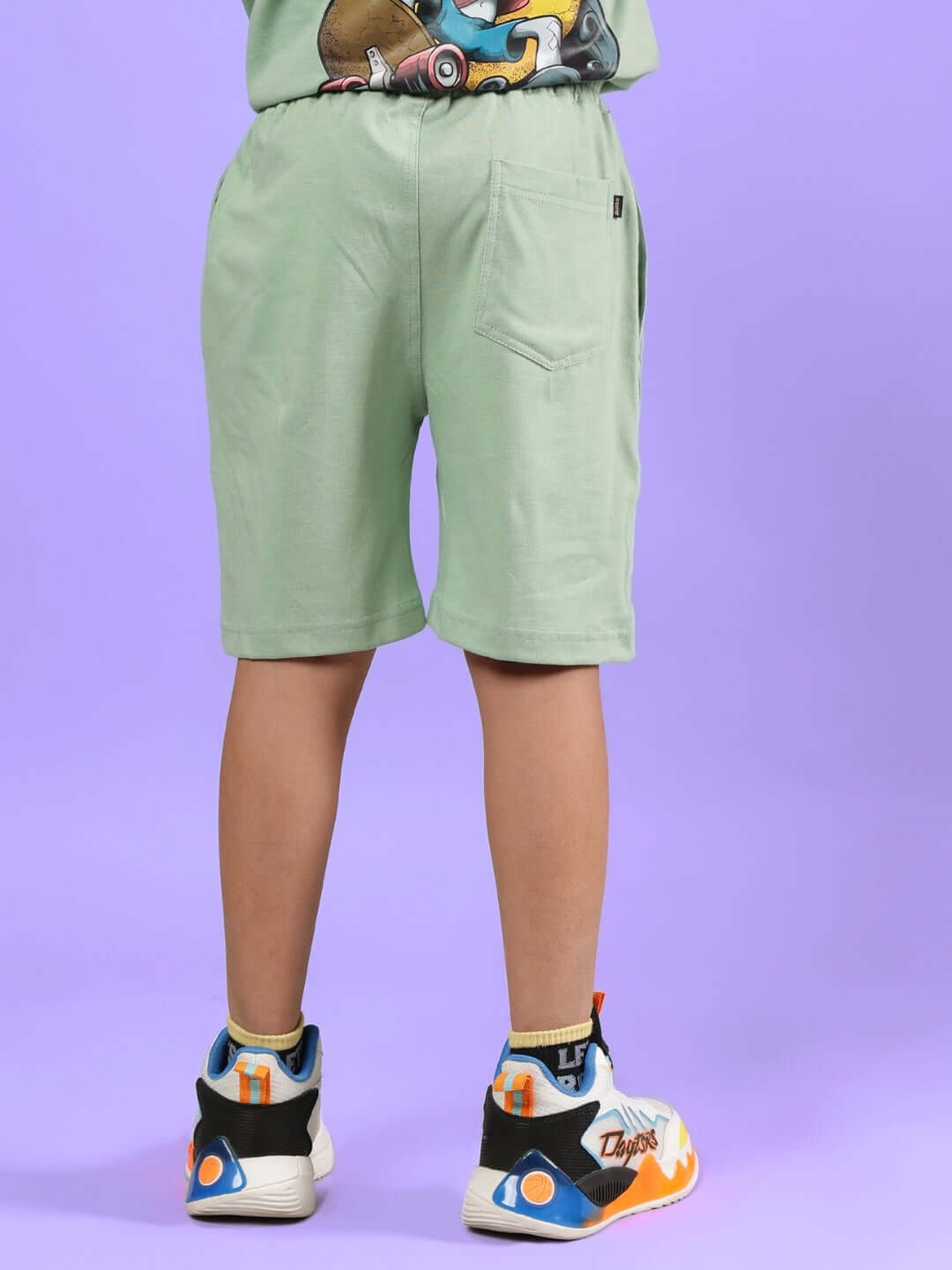 Back view of DUCK TALES SHORTS FOR BOYS & GIRLS NYANZA GREEN worn by a child, showcasing stylish design and comfort.