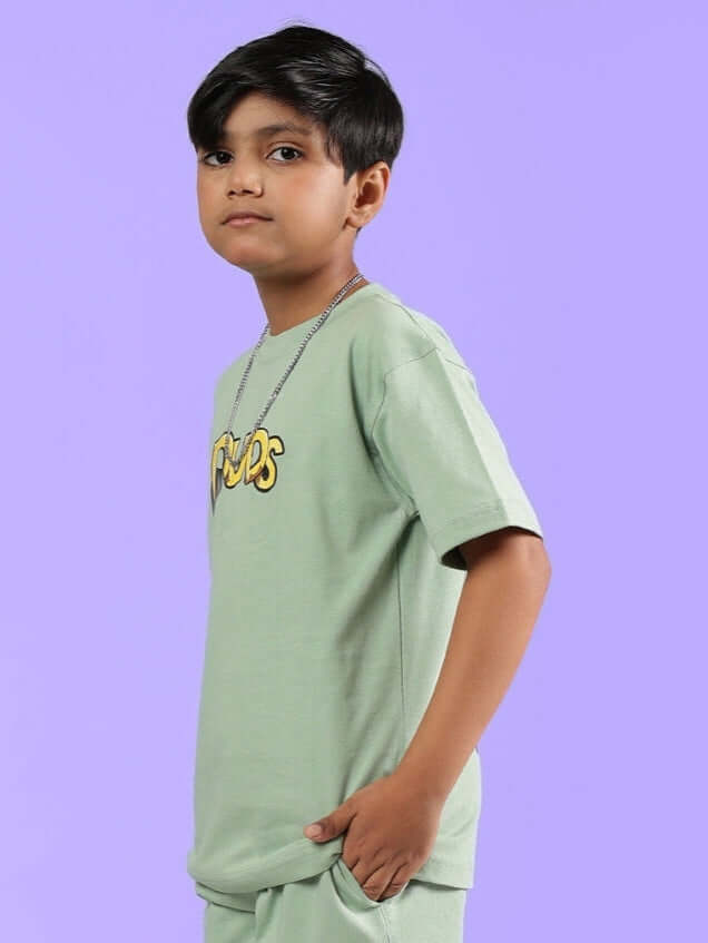 Boy wearing DUCK TALES T-SHIRT FOR BOYS GIRLS NYANZA GREEN, side view with graphic detail, perfect for adventure-loving kids.