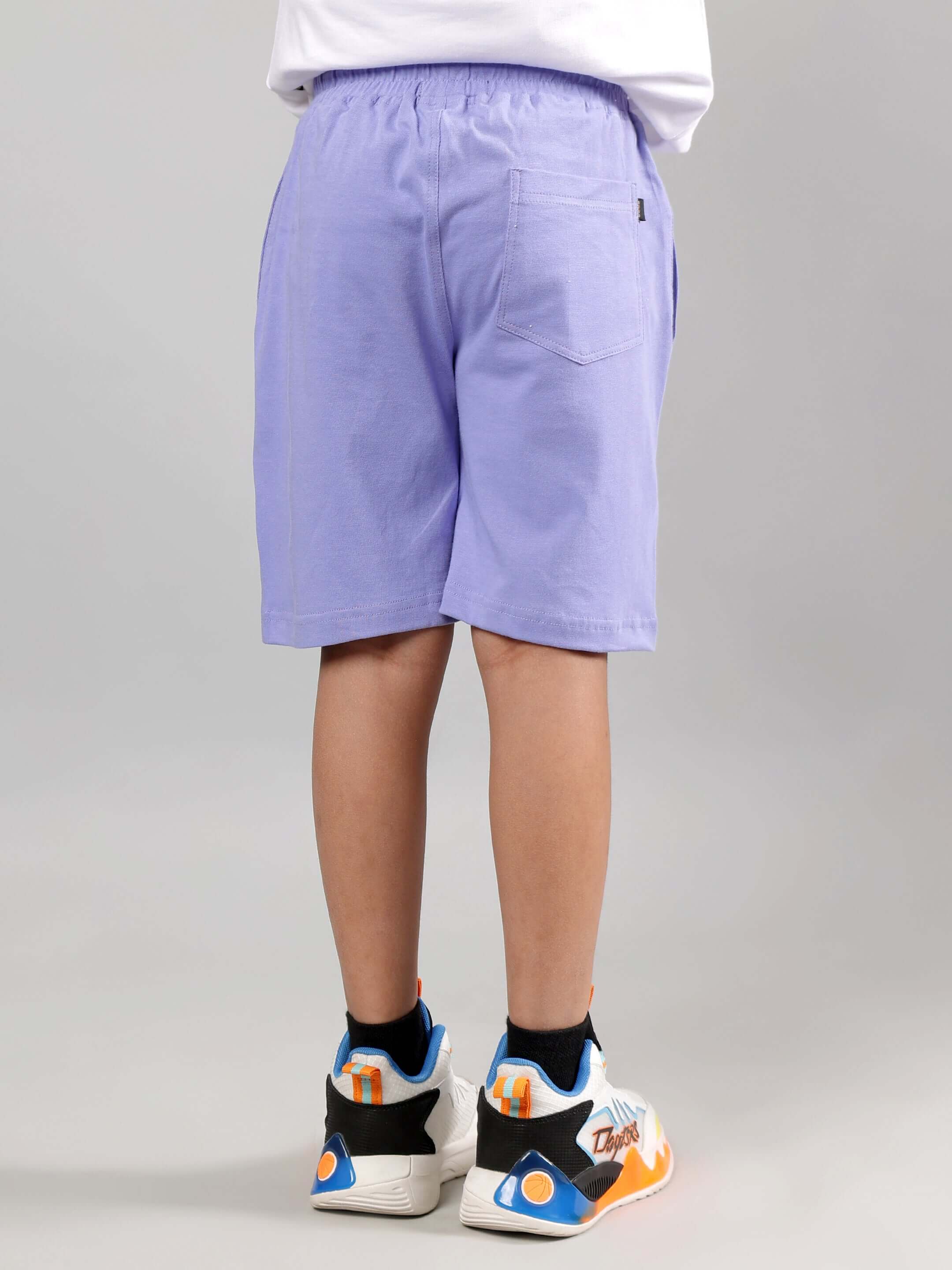 Child wearing DUCK PLAY CO-ORD FOR BOYS GIRLS WHITE LAVENDER showcasing lavender shorts, view from the back.