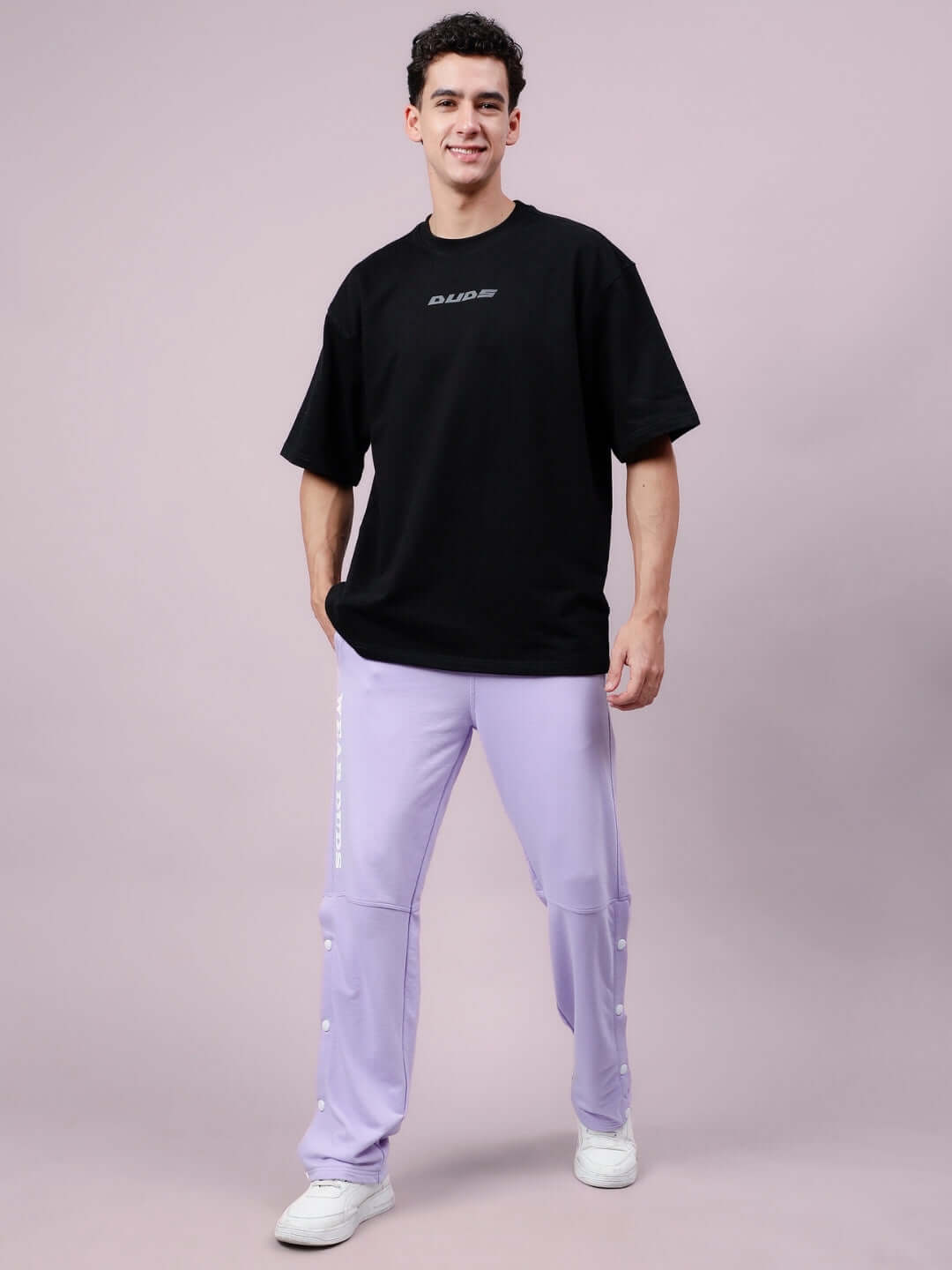 Man wearing DUDS Racer Joggers in lavender with a black t-shirt, showcasing style and comfort