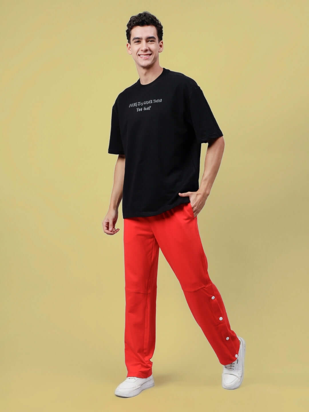 Man wearing DUDS Racer Joggers in red with customizable fit option.