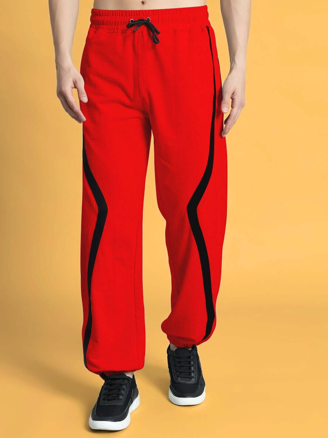 Red DUDS frame joggers with black accents, customizable fit available. Tailored comfort by experienced DUDS tailors, made-to-order.