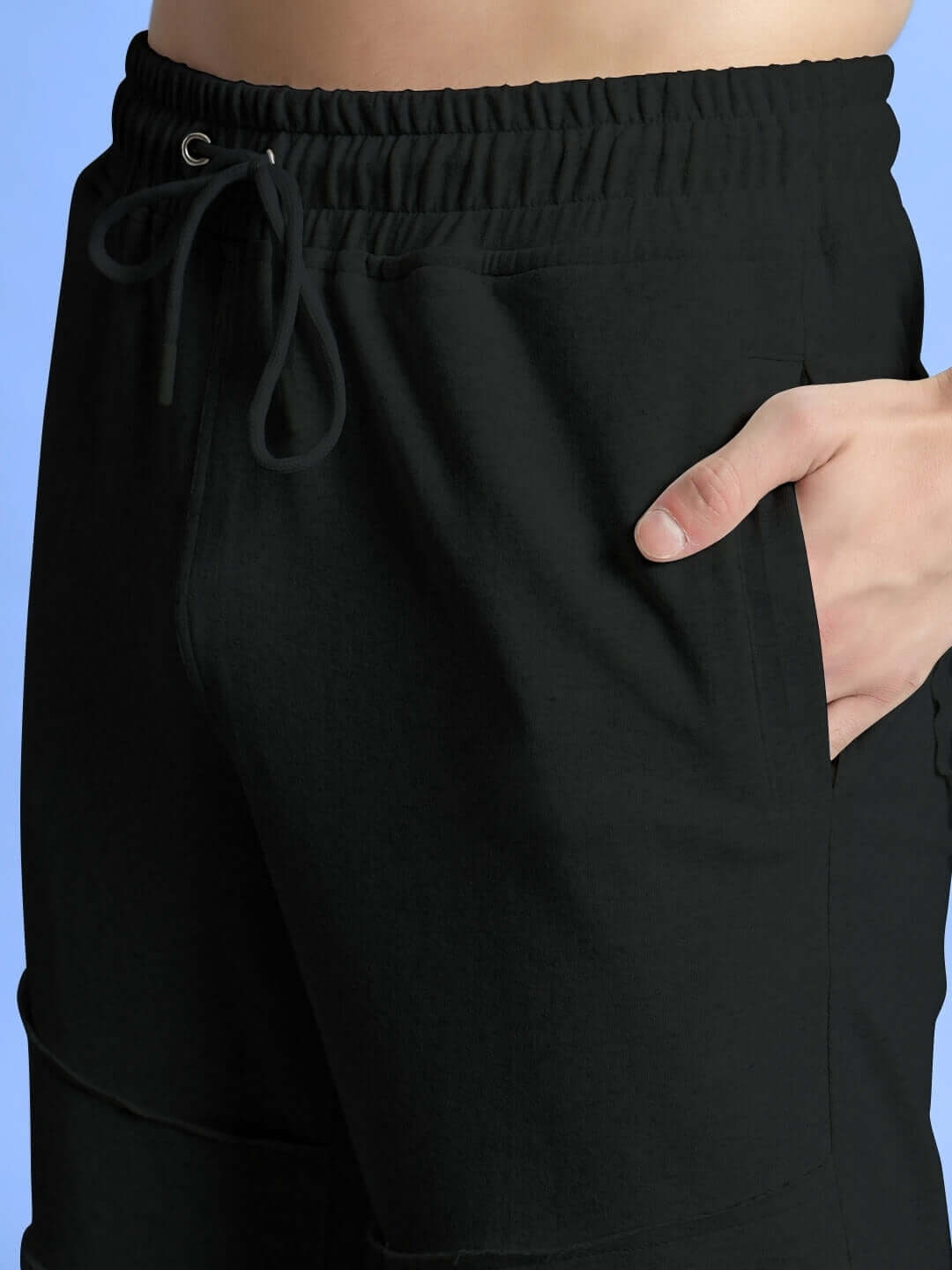 Close-up of WEARDUDS GRAZE JOGGERS COTTON BLACK with elastic waistband and pocket detail for comfort and style.
