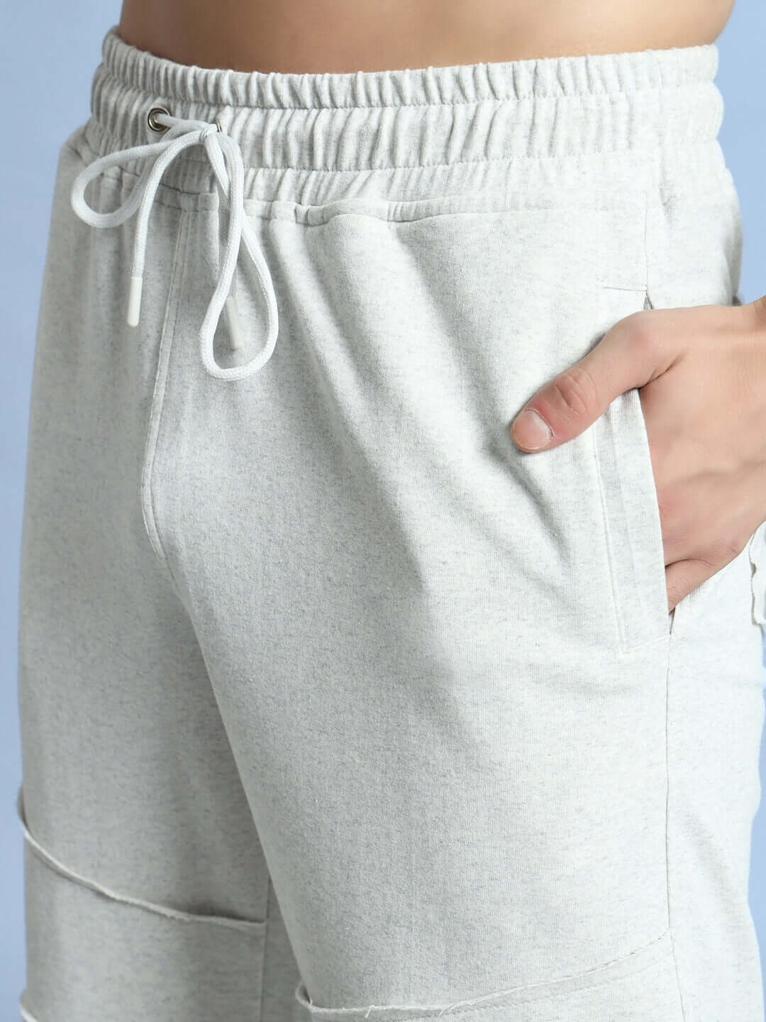 Close-up of DUDS Graze Joggers in Melange Grey showing adjustable drawstring and pocket detail.