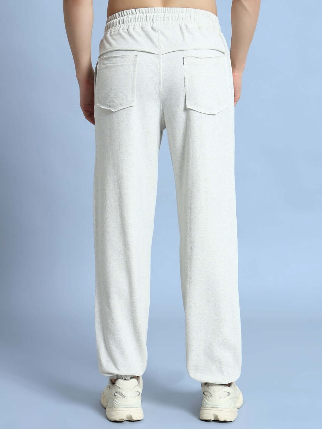 Back view of DUDS GRAZE Joggers in melange grey, showcasing relaxed fit and pocket design, made by skilled tailors for custom fit.