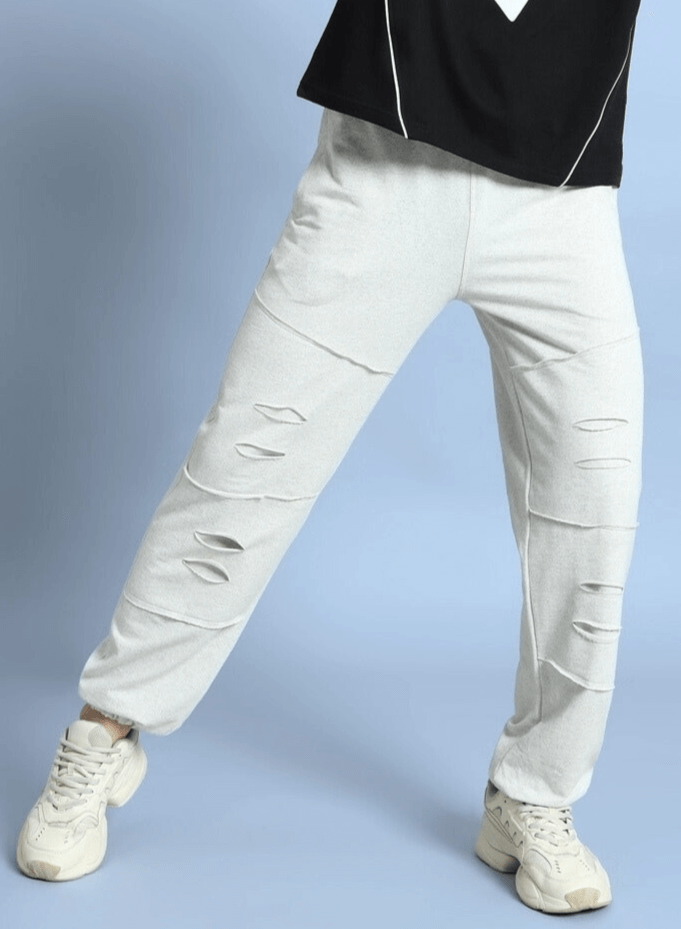 Person wearing DUDS Graze Joggers in melange grey with stylish cut-out design, perfect for a comfortable custom fit look.