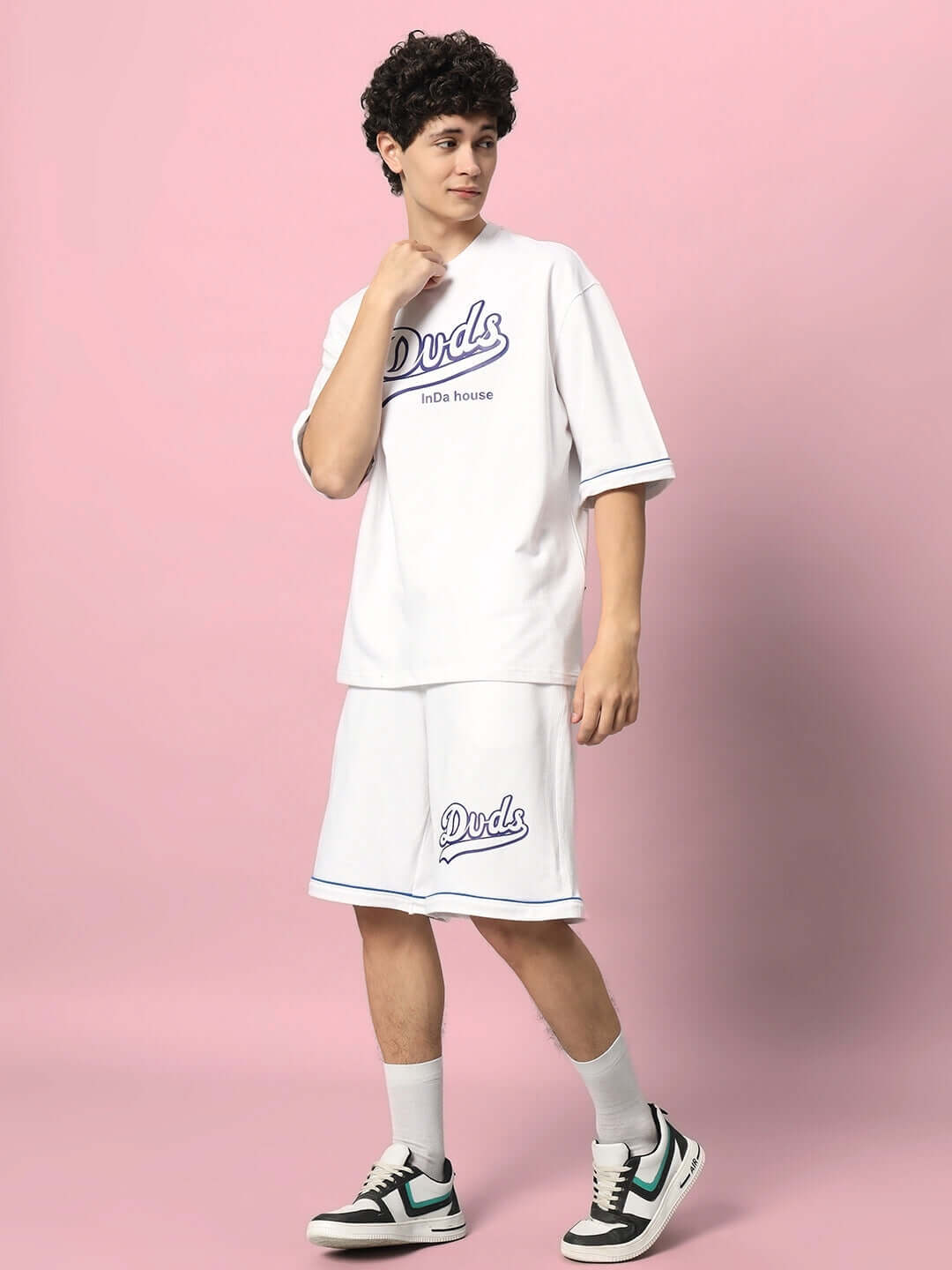 Model wearing DUDS INDA HOUSE white colorblock co-ord set with premium cotton fabric on a pink background.