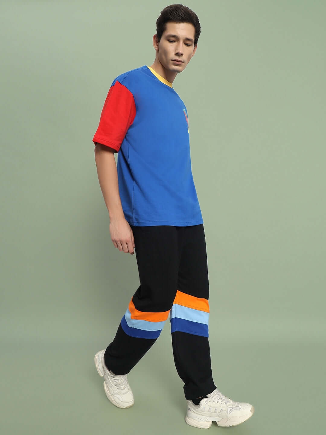 Model wearing DUDS Jasper Joggers in Black, showcasing casual style with color-blocked top, highlighting comfort and fashion appeal for DUDS clothing.