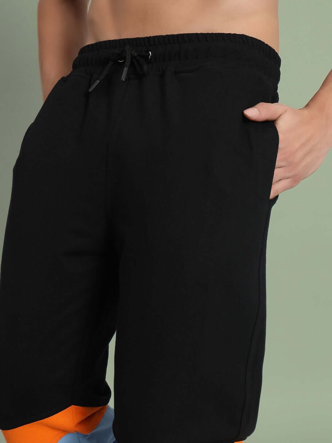 Person wearing DUDS Jasper Joggers in black, showcasing a custom-fit design for comfort and style with an elastic waistband.
