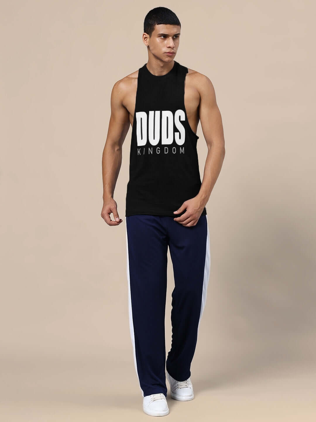 Model wearing DUDS KINGDOM GYM CO-ORD SET BLACK NAVY-BLUE, featuring unisex relaxed fit joggers and a black tank top with logo.
