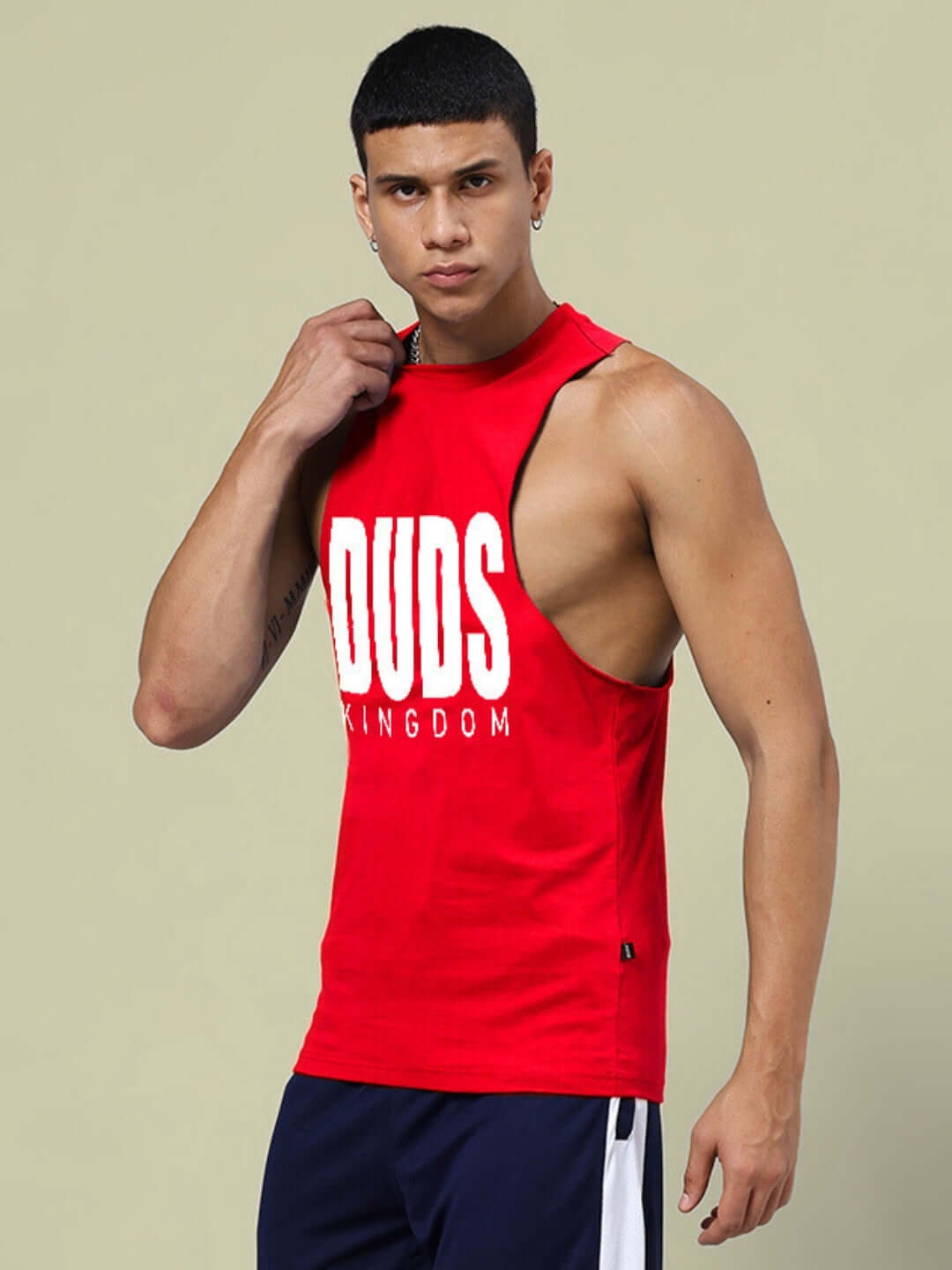 Man wearing DUDS KINGDOM red gym T-shirt, showcasing custom fit option for athletic wear.