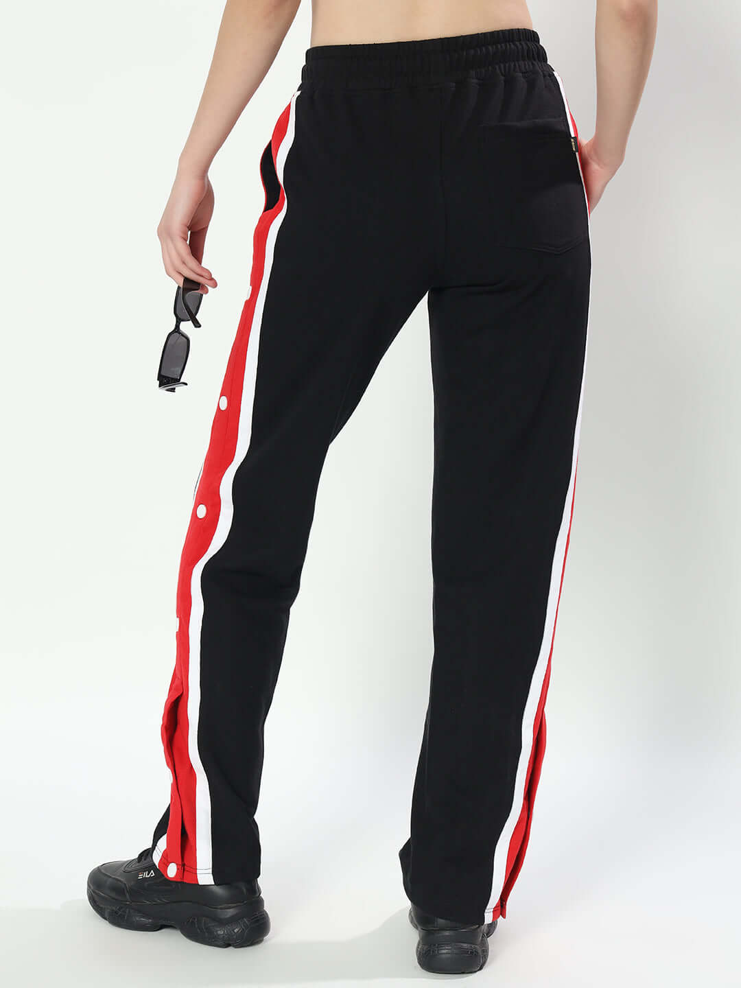 Back view of DUDS Magician Jogger for Women in Black with red and white side stripes, featuring elastic waistband and comfortable fit.