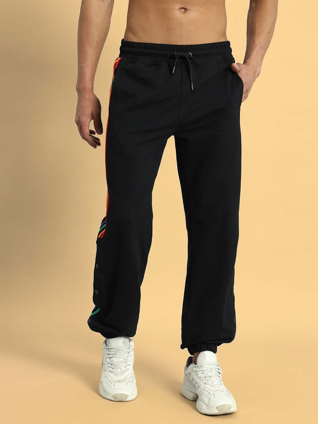 Black joggers with colorful stripe design by DUDS, showcasing a modern athletic style. Perfect for custom fit and made-to-order purchase.