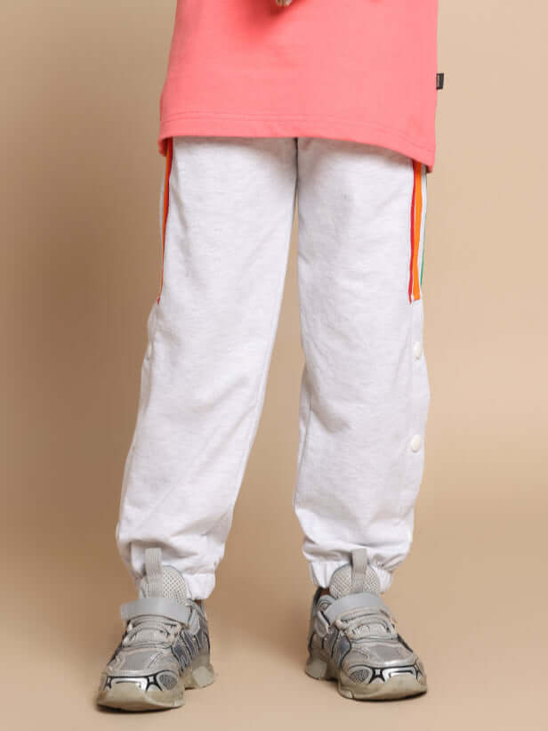 DUDS Prism colorful stripe jogger for boys and girls in melange grey, showcasing elastic cuffs and vibrant side stripes, perfect for custom fit.