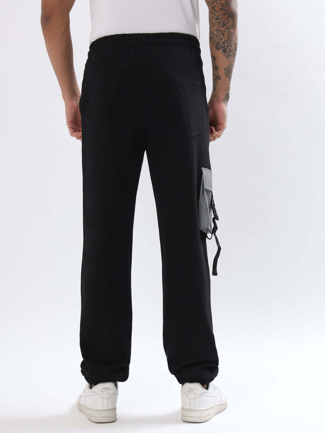 Back view of DUDS black smiley reflector cargo jogger showcasing side pocket detail.