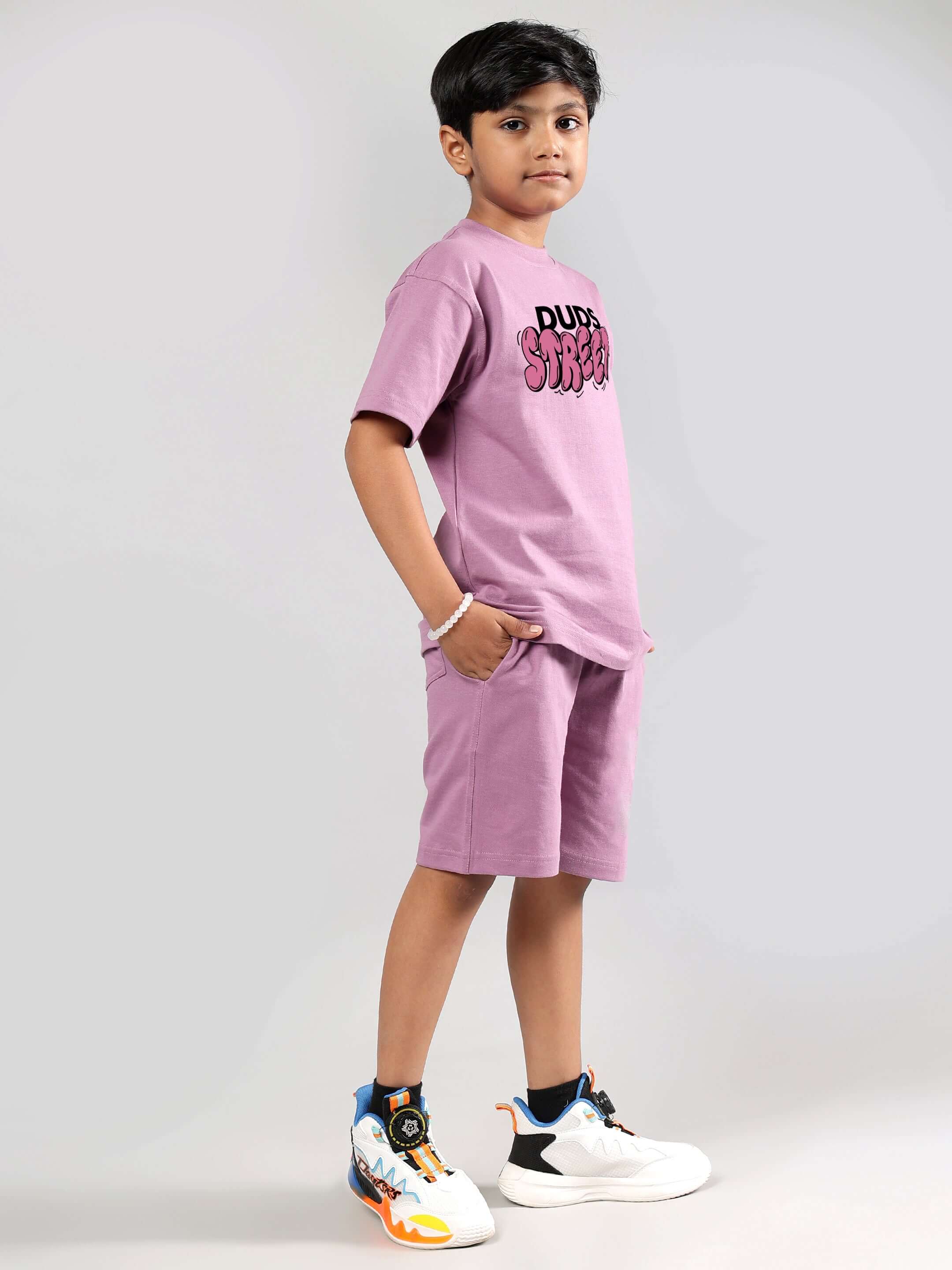 Child wearing plum purple DUDS STREET co-ord set, featuring t-shirt and shorts, ready for casual outings.