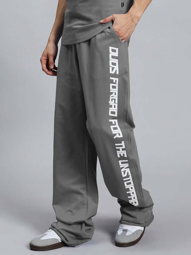 Model wearing DUDS SWIFT JOGGER COTTON TERRY GREY with white sneakers, side view showing design details and comfort fit.