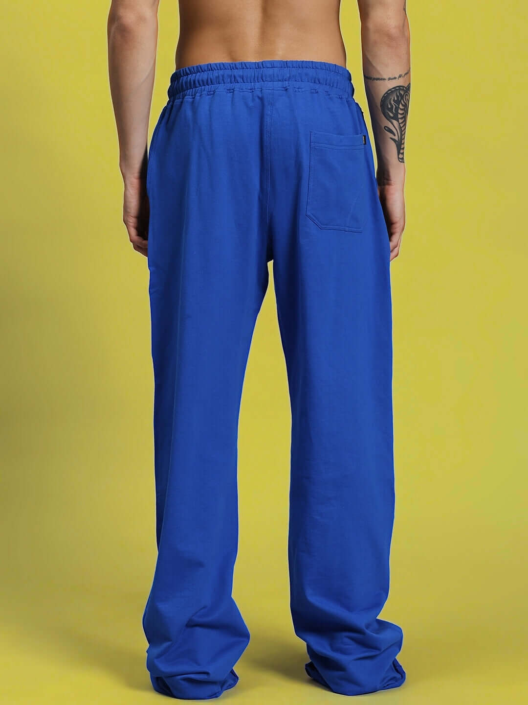 Back view of DUDS SWIFT Jogger in royal blue, showcasing relaxed fit and pocket detail, made with care by experienced tailors.