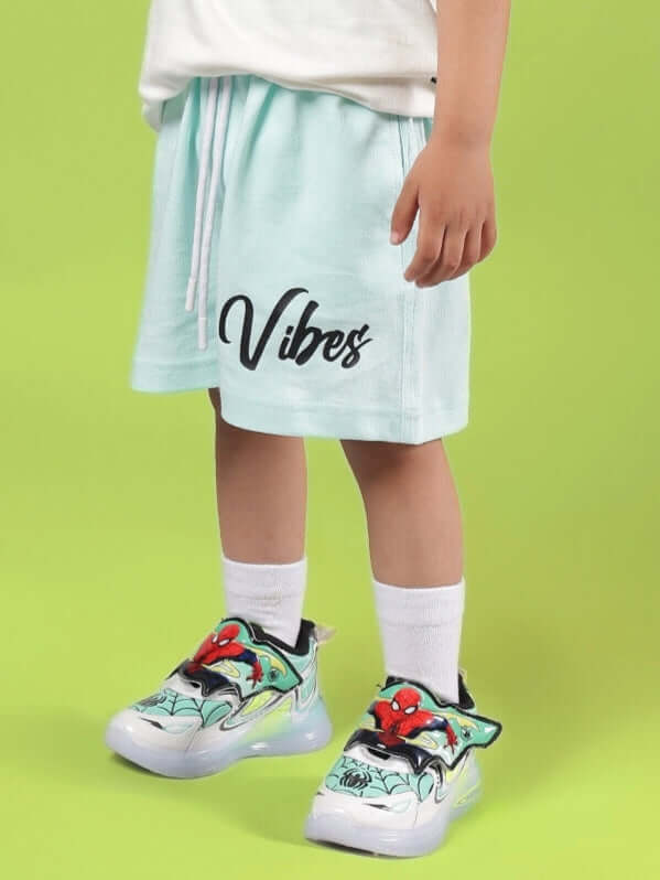 Child wearing DUDS VIBES SHORTS FOR BOYS & GIRLS SKY BLUE with colorful sneakers.