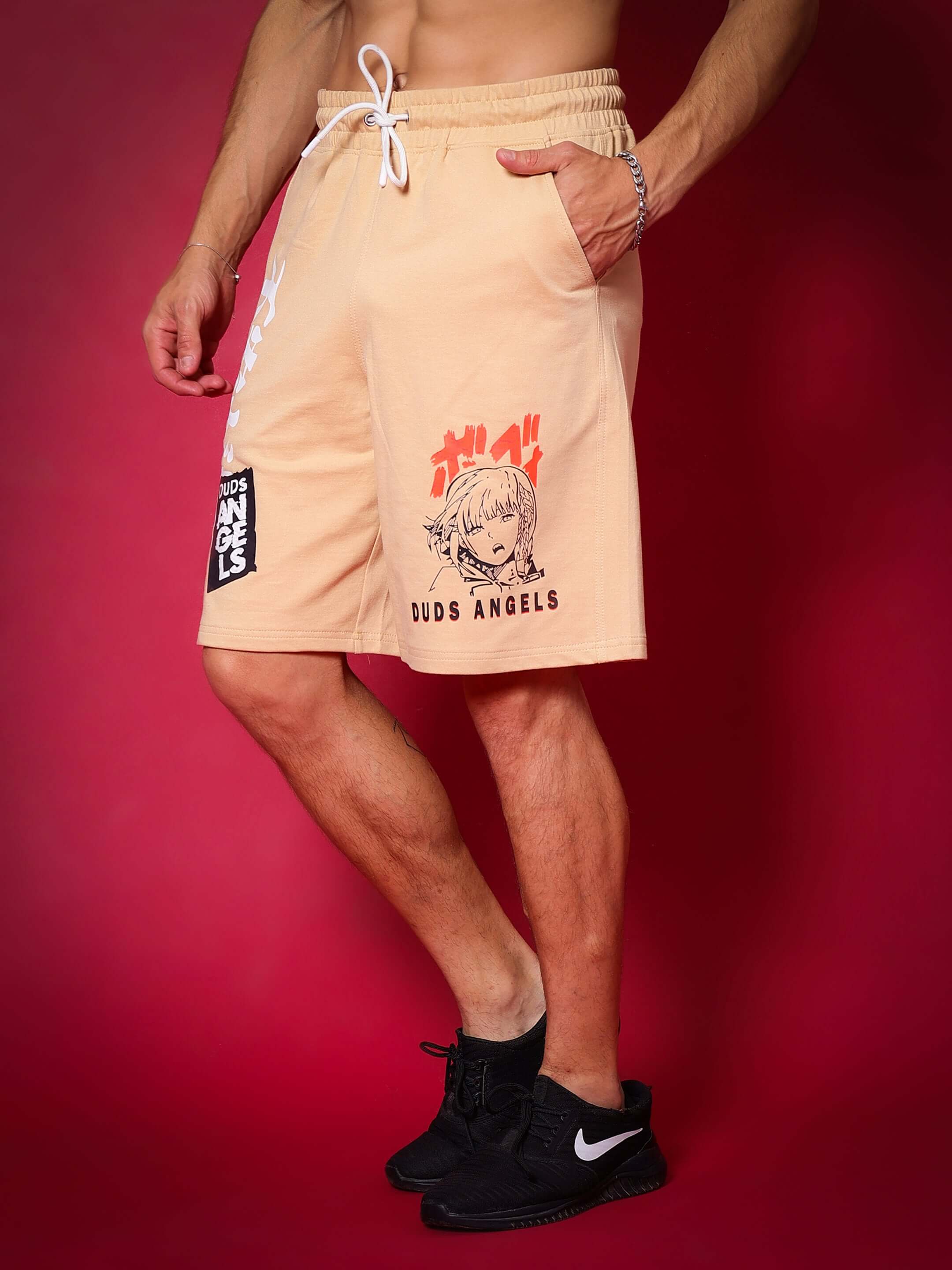 Light orange anime girl shorts by DUDS, regular fit with customizable sizes for prepaid orders, model wearing against red background.