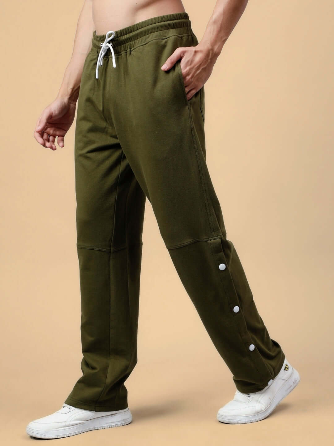 Olive green DUDS Racer Joggers with side buttons, customizable fit, tailored by skilled craftsmen, shown on a model.