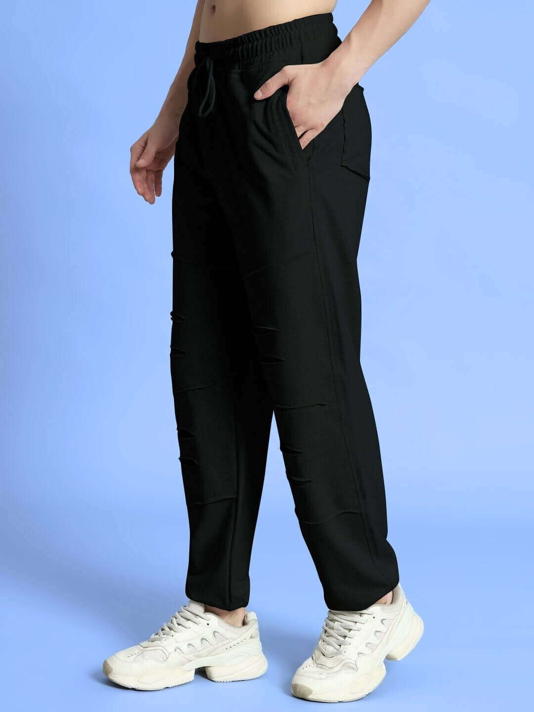 Person wearing WEARDUDS GRAZE JOGGERS COTTON BLACK with white sneakers, showcasing comfort and style for modern lifestyles.