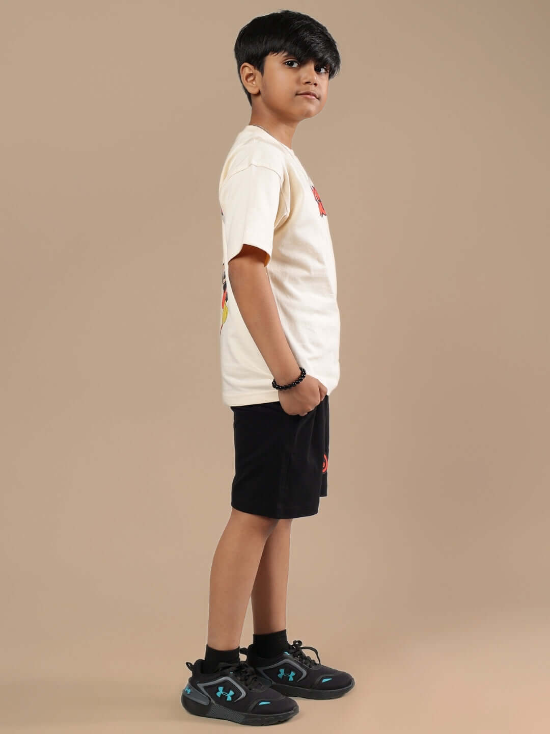 Boy wearing DUDS MOUSE CO-ORD FOR BOYS & GIRLS BEIGE-BLACK outfit, featuring a beige shirt and black shorts.