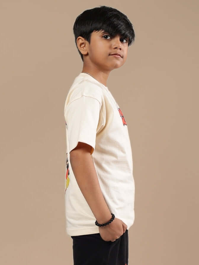 Child wearing DUDS MOUSE T-SHIRT FOR BOYS GIRLS OFF WHITE in side profile view, displaying the unisex design and comfortable fit.