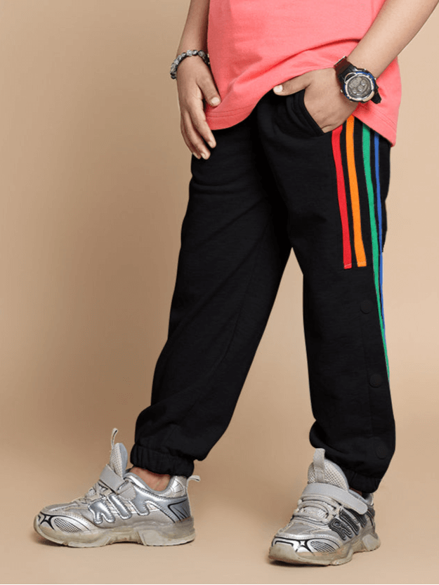 Child wearing DUDS Prism Colorful Stripe Jogger in Black with rainbow stripes, suitable for boys and girls. Comfortable and stylish design.